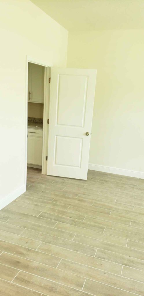 Empty room with tile floor and white door